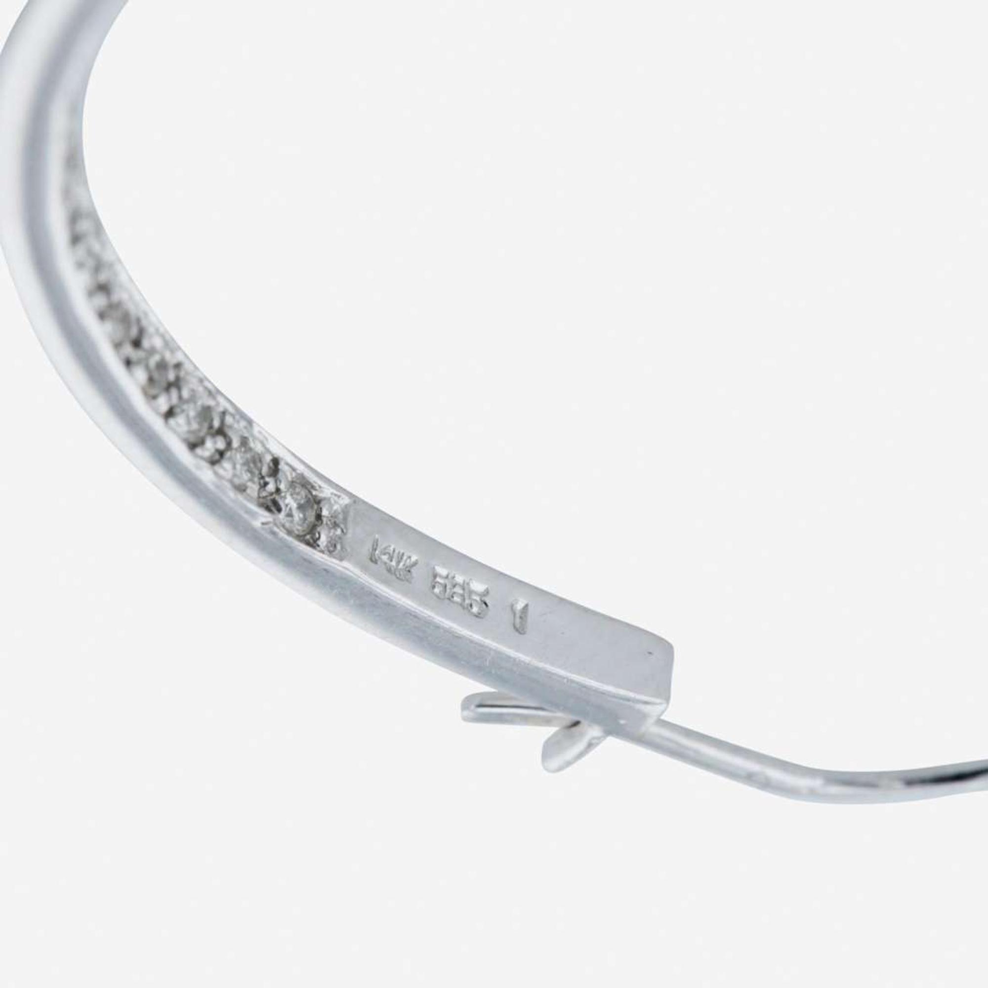 A pair of 14K white gold and diamond hoop earrings