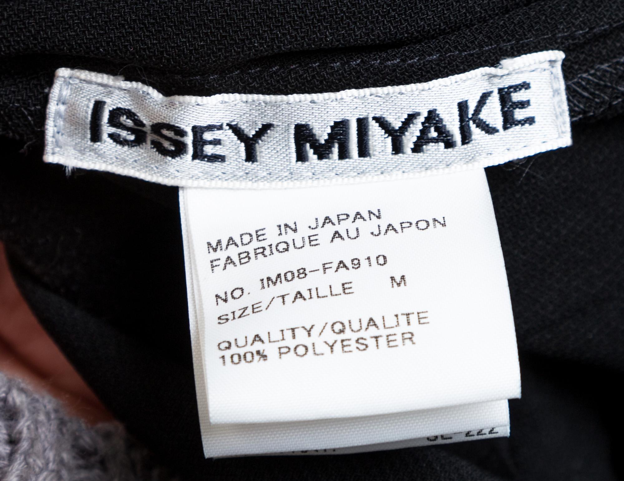 An Issey Miyake Black Pleated Coat, Size medium.