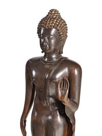 A Large Thai Bronze Figure of Walking Buddha