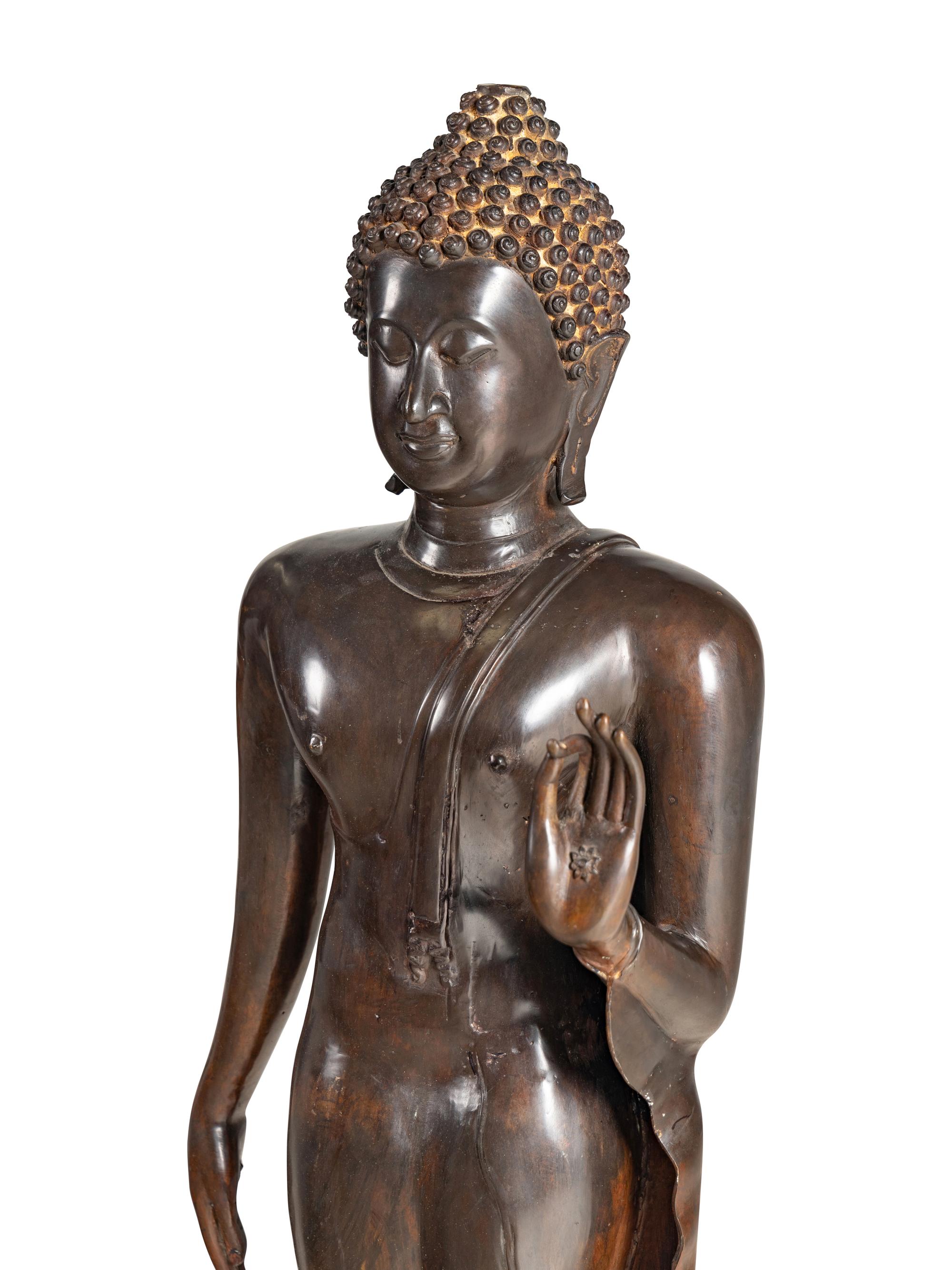 A Large Thai Bronze Figure of Walking Buddha