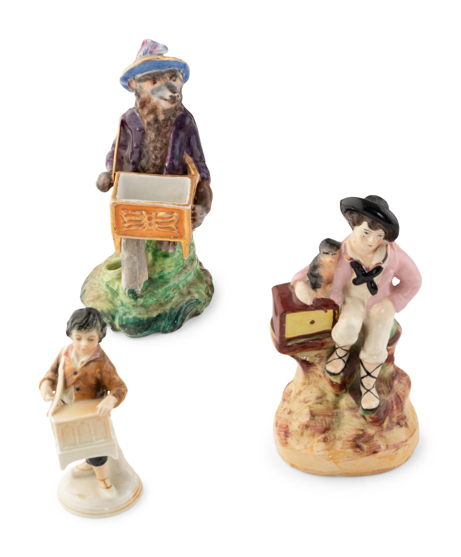 A Group of Fourteen Street Organist Figurines