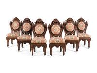 A Set of Six Rococo Revival Carved Oak Dining Chairs