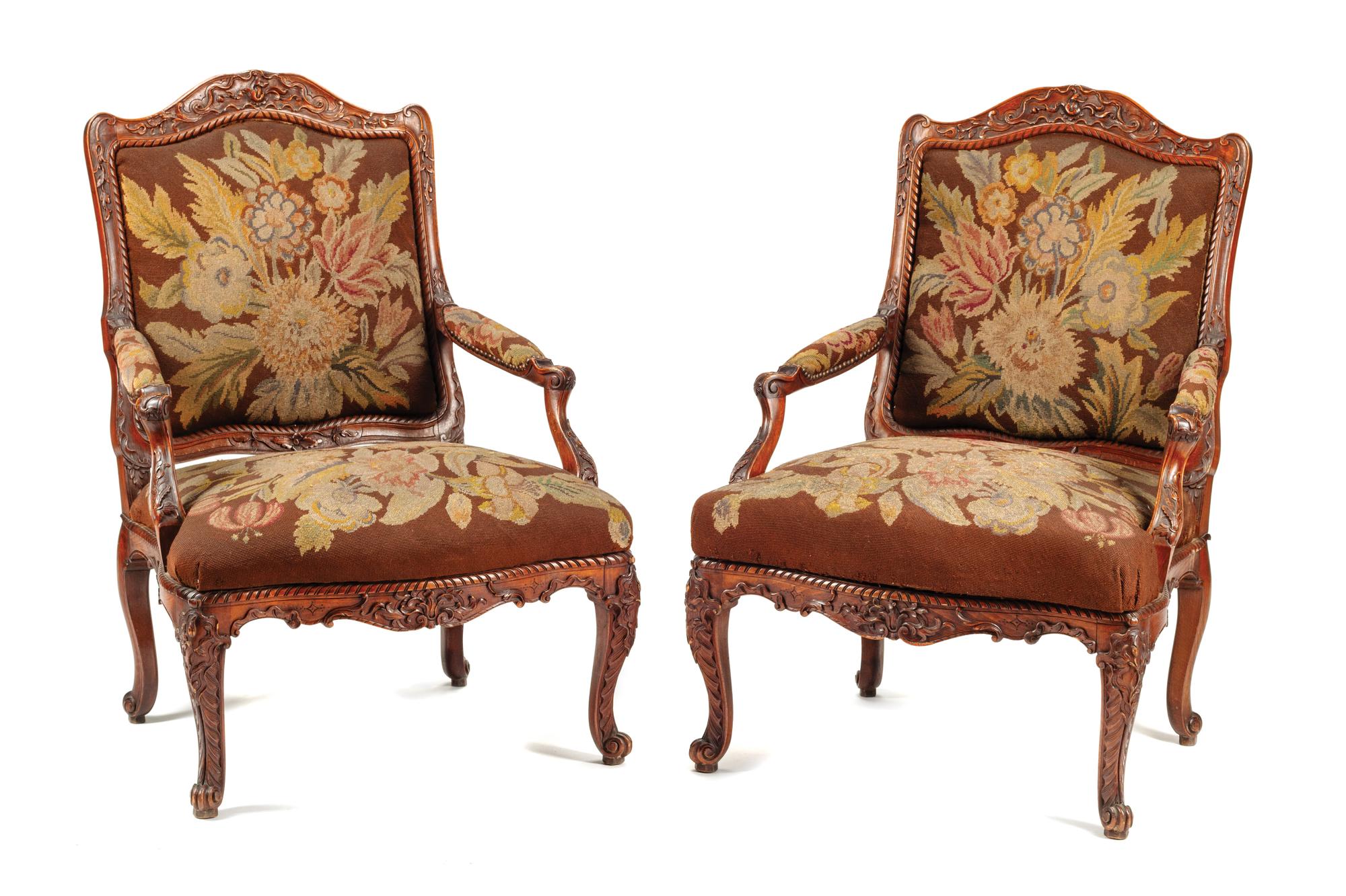A Pair of Régence Style Carved Walnut Fauteuils
