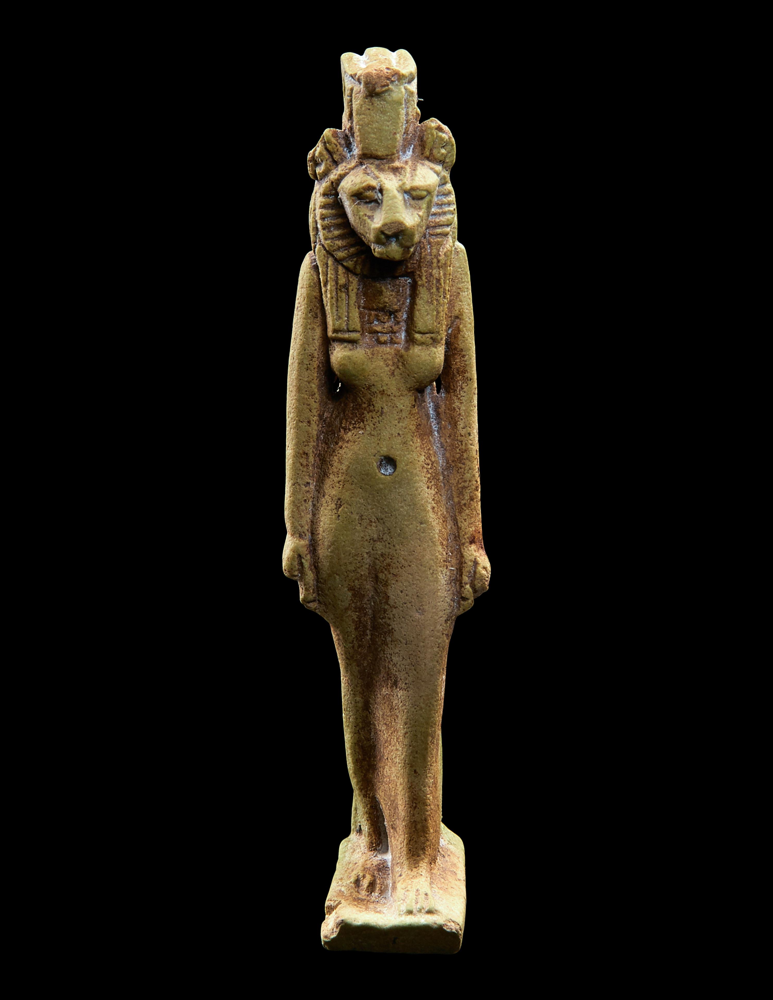 An Egyptian Faience Striding Sekhmet