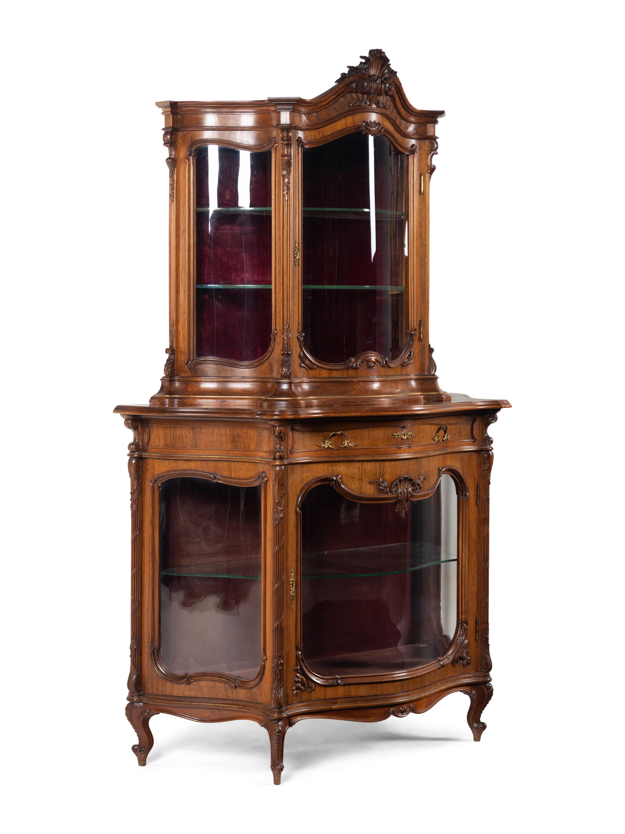 A Rococo Revival Carved Walnut Corner Vitrine Cabinet