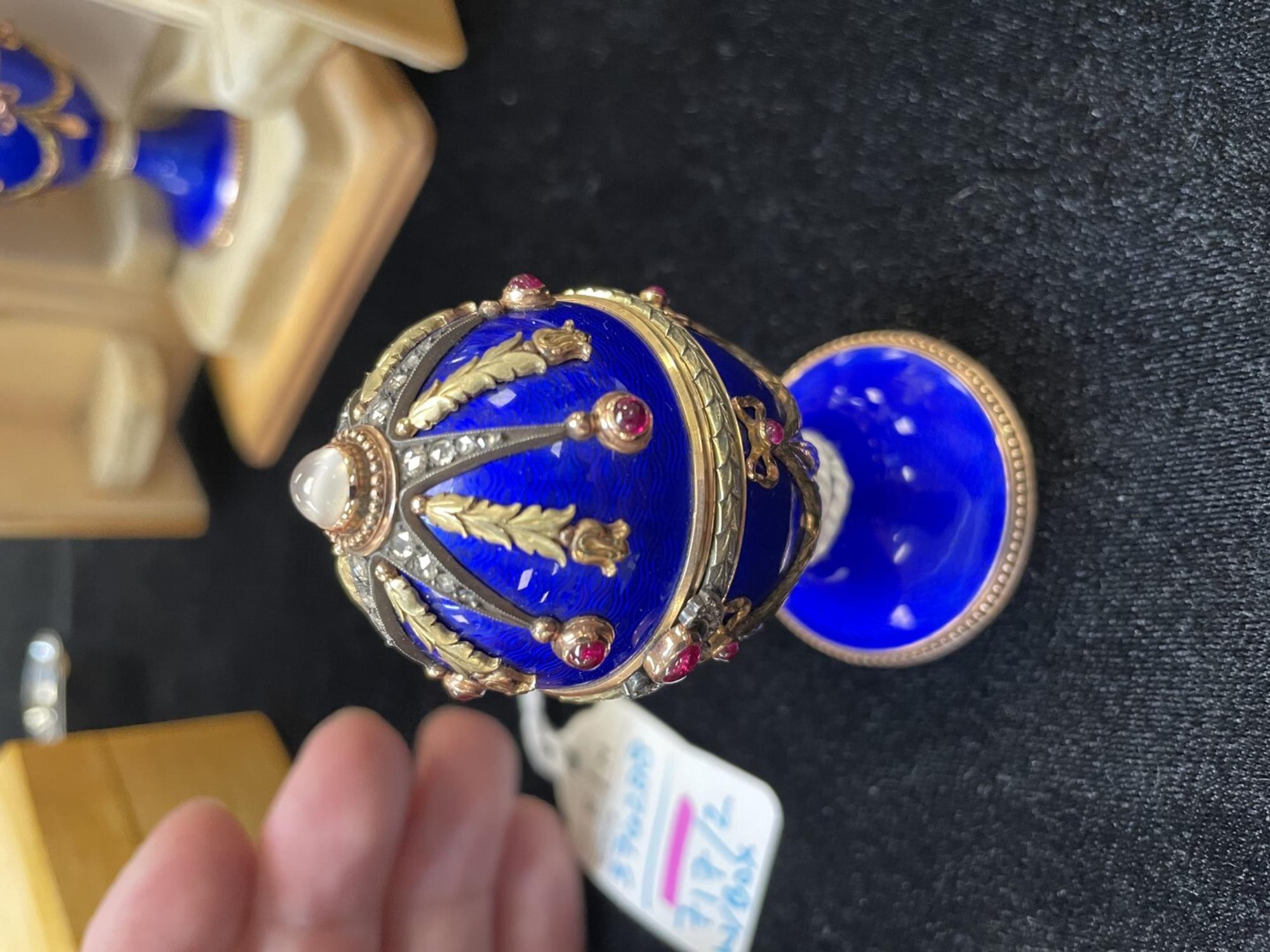 A 14 Karat Vari-Color Gold, Guilloché Enamel, Diamond, and Cabochon Jewel-Mounted Egg-Form Perfume and a Related Guilloché Enamel, 14 Karat Vari-Color Gold, Diamond, and Cabochon-Mounted Surprise Egg
