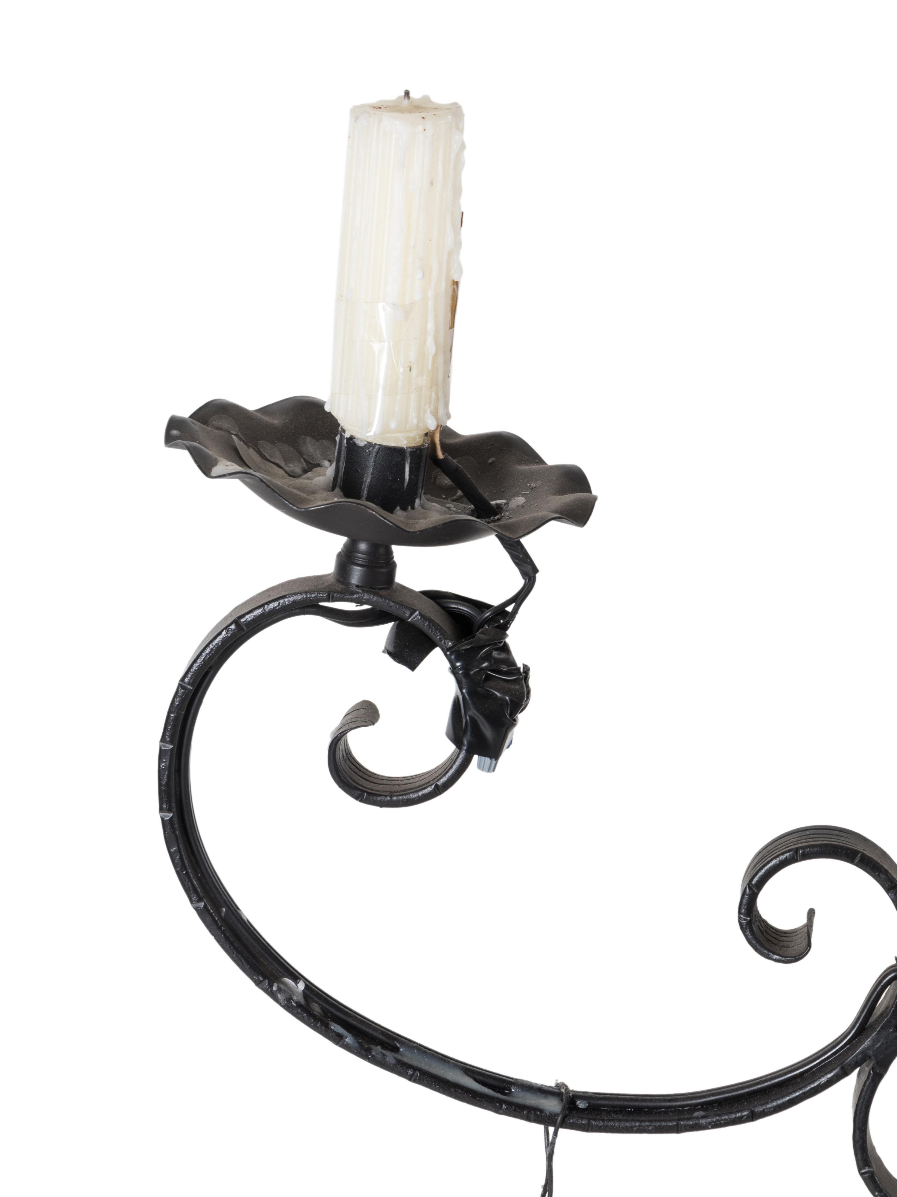 A Black-Painted Wrought Metal Twelve-Light Chandelier