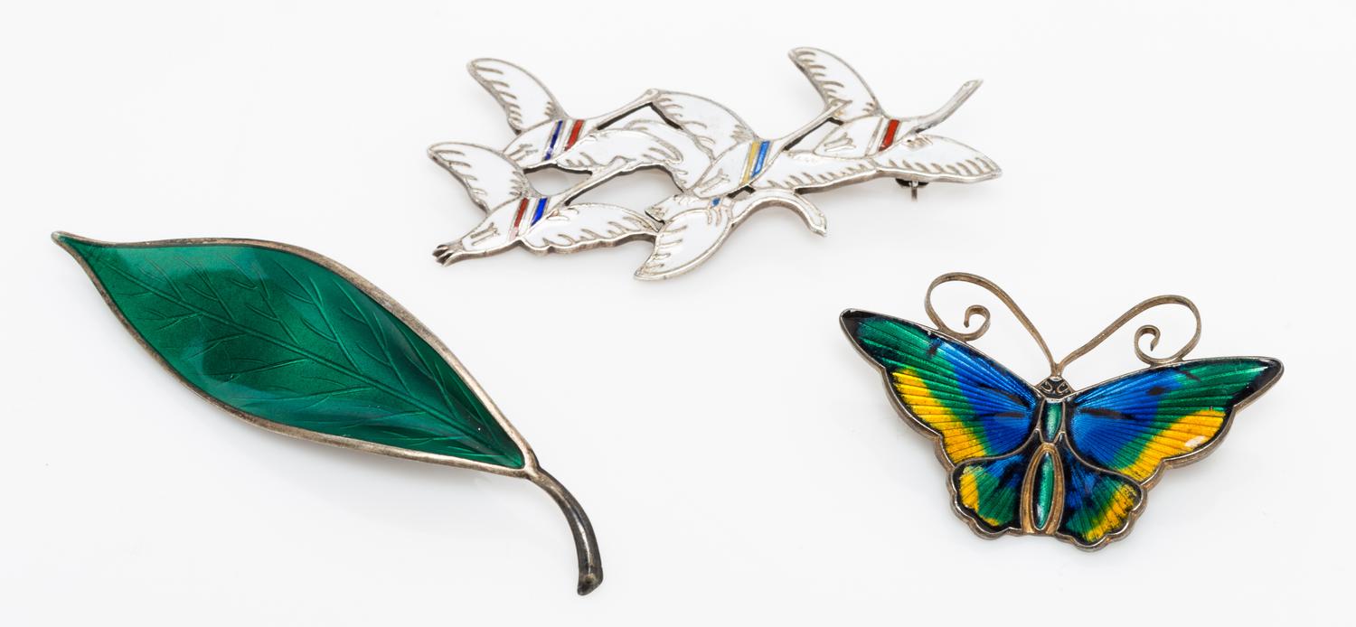 A Collection of Gilt Silver and Polychrome Enamel Brooches, 19.40 dwts.