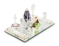 A Collection of Eleven Glass Perfume Bottles and a Mirrored Glass Tray