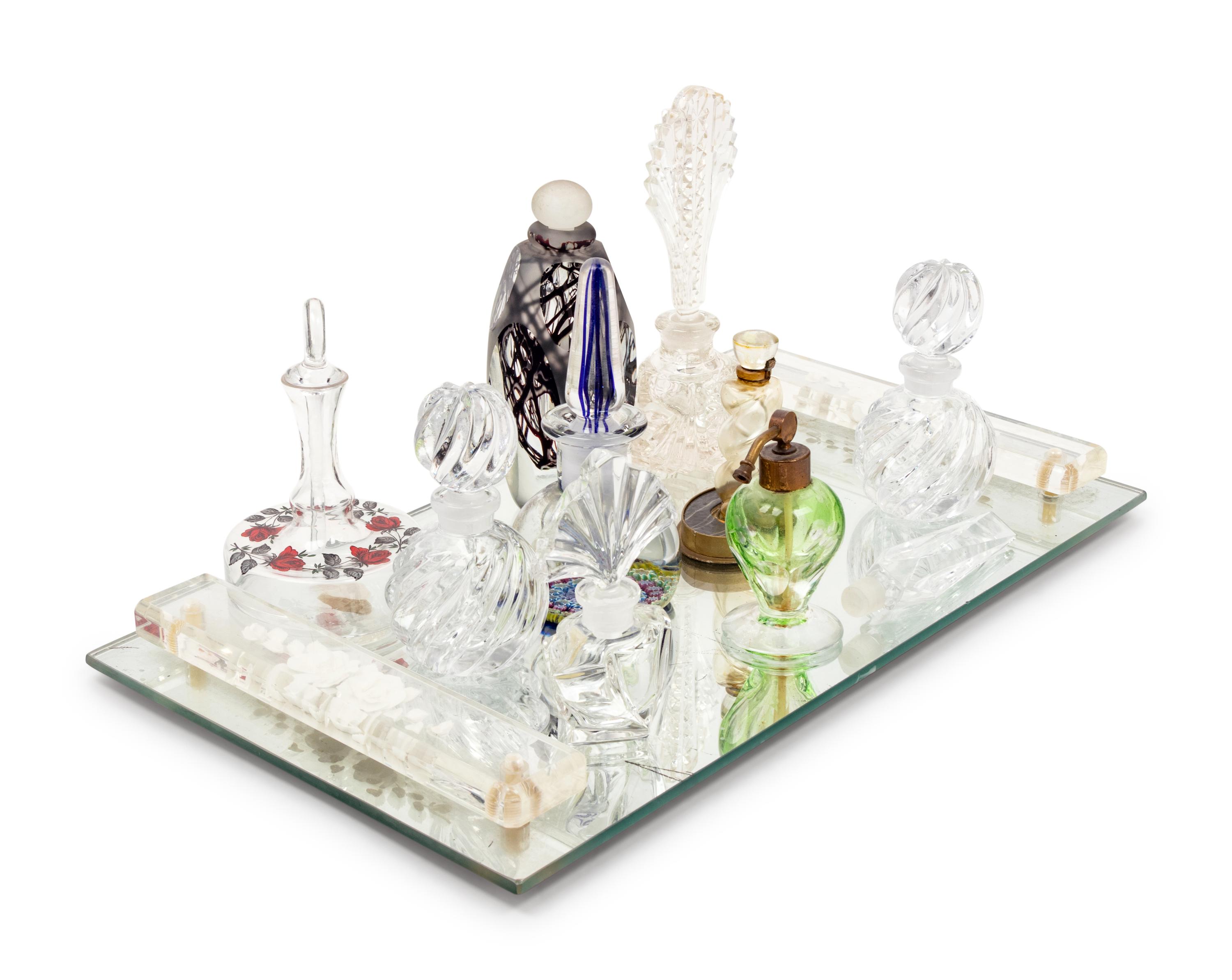 A Collection of Eleven Glass Perfume Bottles and a Mirrored Glass Tray