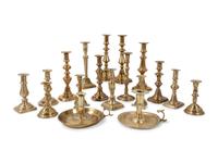 A Large Group of English Brass Candlesticks and Chambersticks