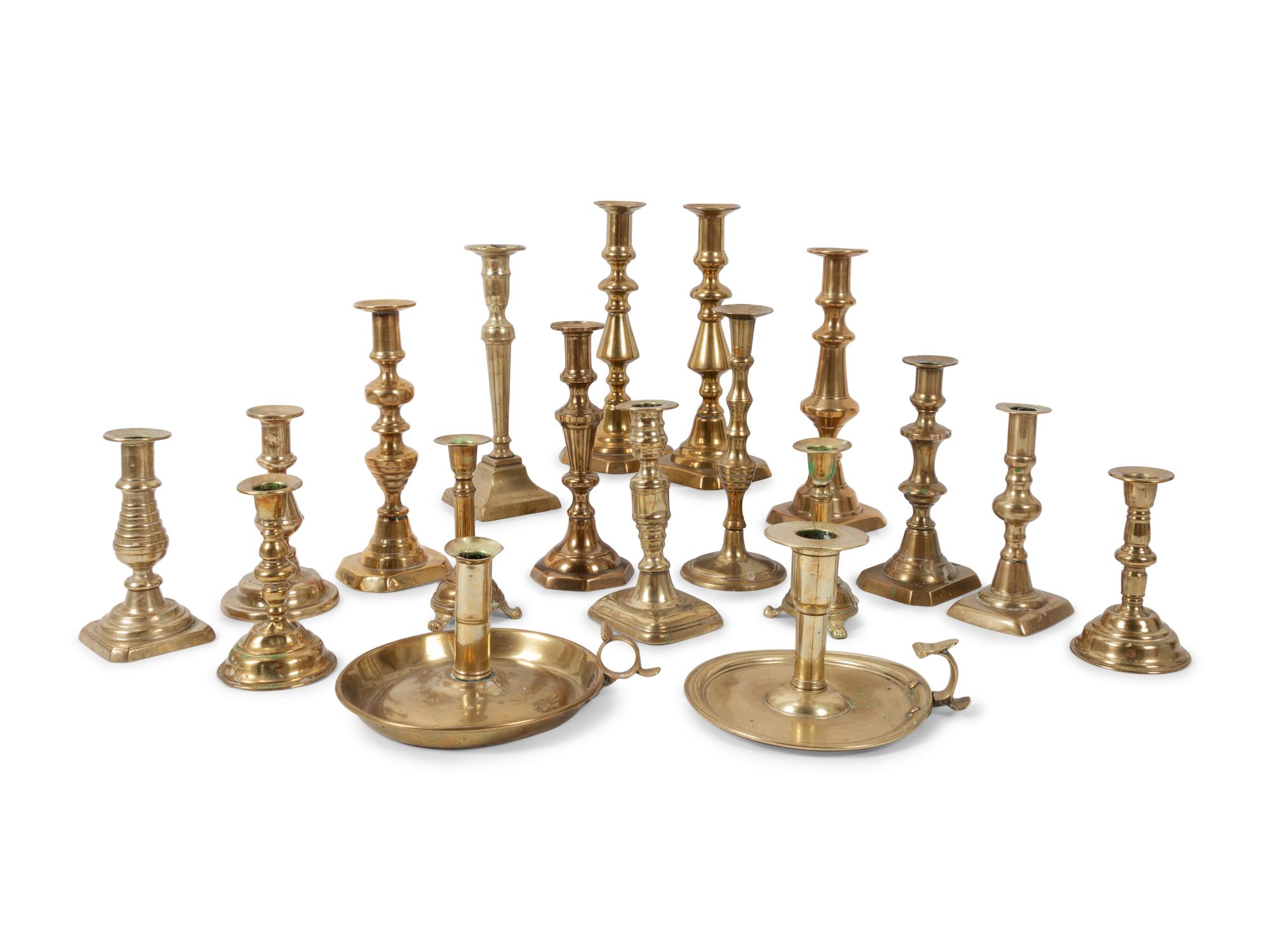 A Large Group of English Brass Candlesticks and Chambersticks