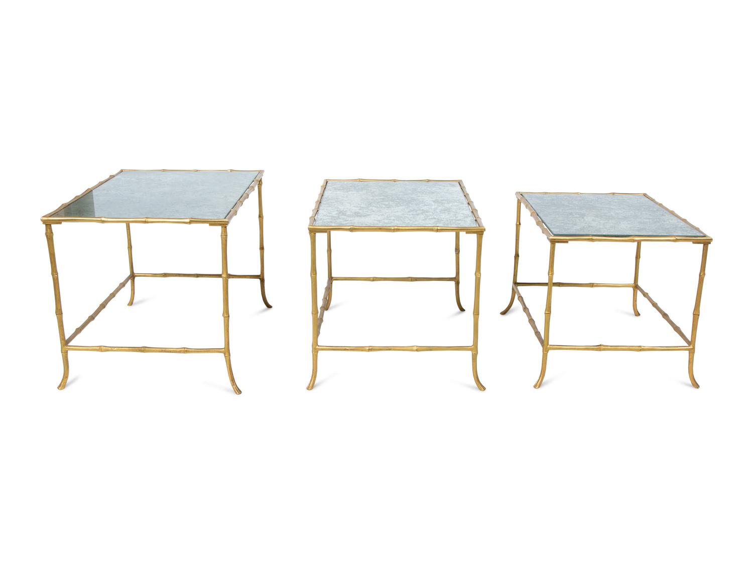A Set of Three Gilt Metal Mirrored Nesting Tables in the Style of Maison Bagues