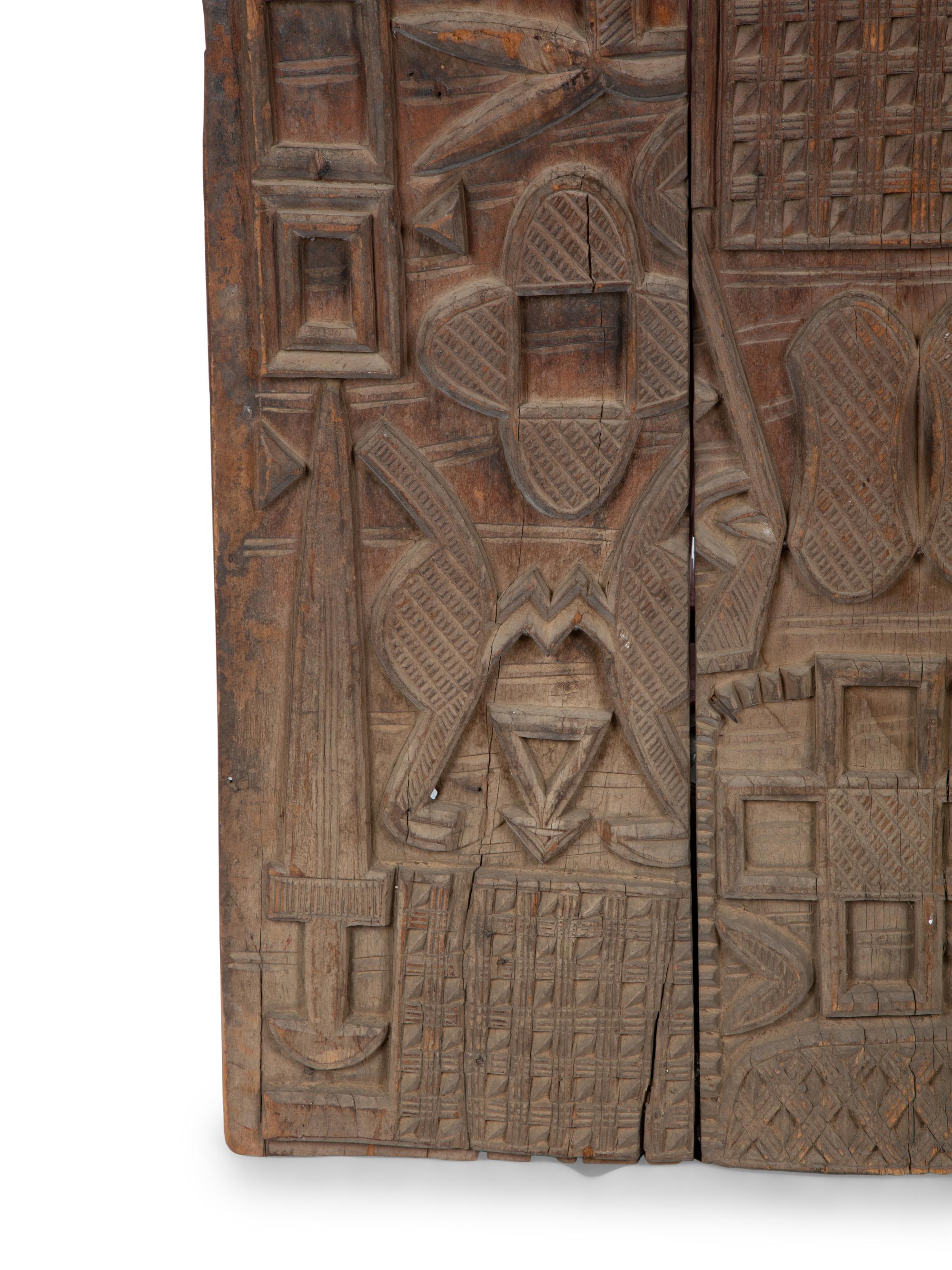 An African Carved Wood Panel — 20TH CENTURY