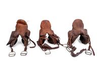 A Group of Three Leather Saddles, Including One by Abercrombie and Fitch