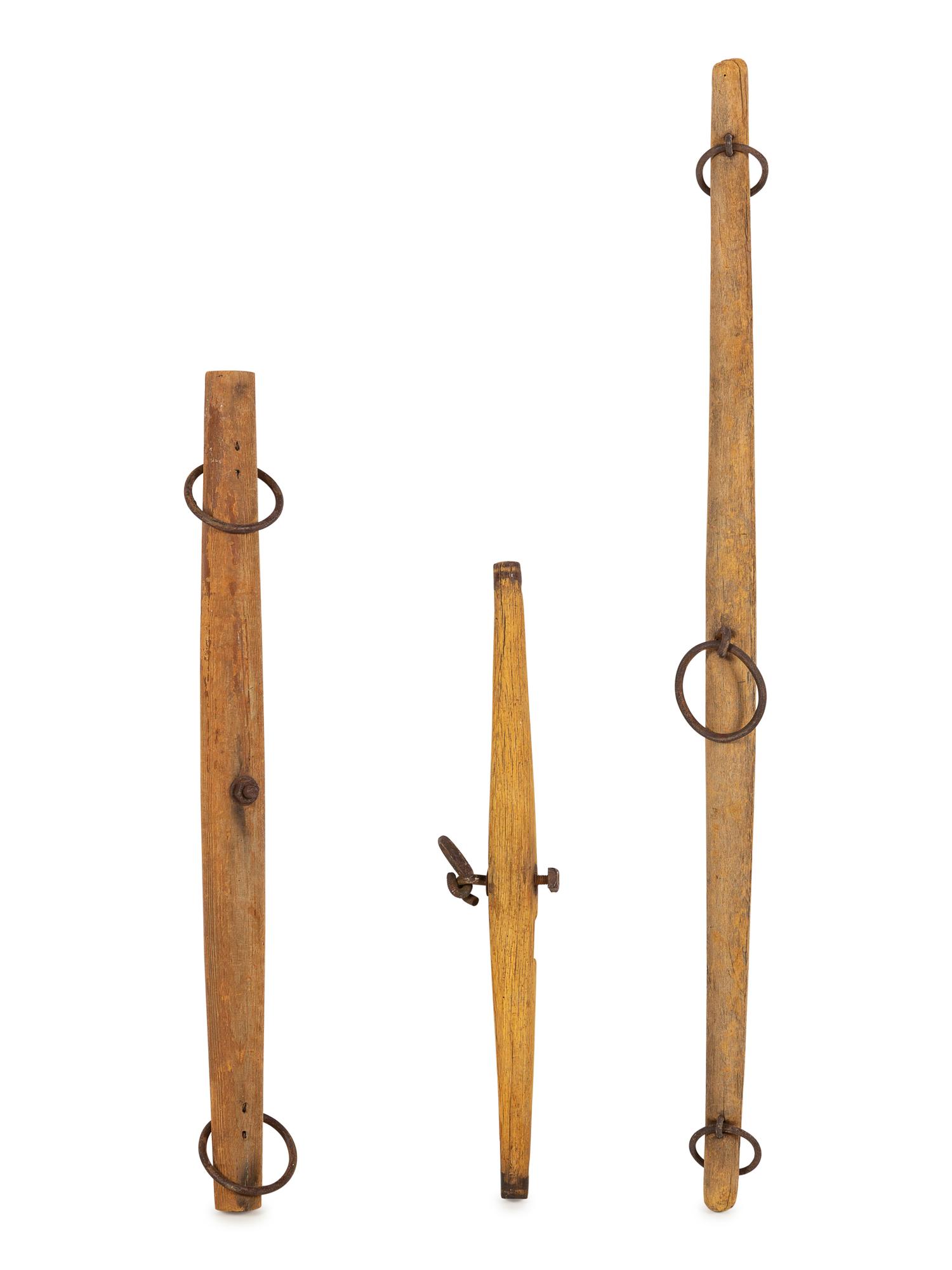 A Group of Three Wood and Iron Yokes