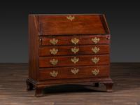 A Chippendale Figured and Shell-Carved Mahogany Slant Front Desk