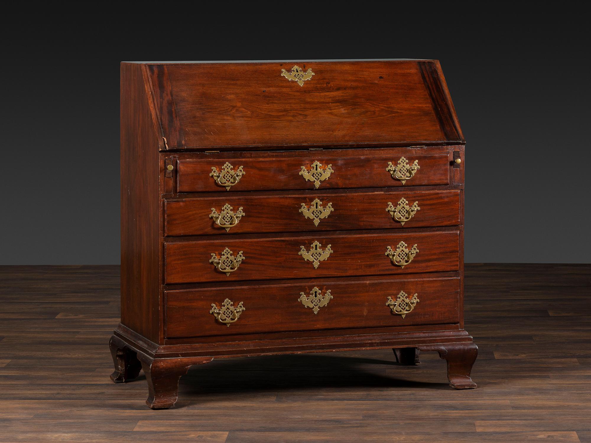 A Chippendale Figured and Shell-Carved Mahogany Slant Front Desk