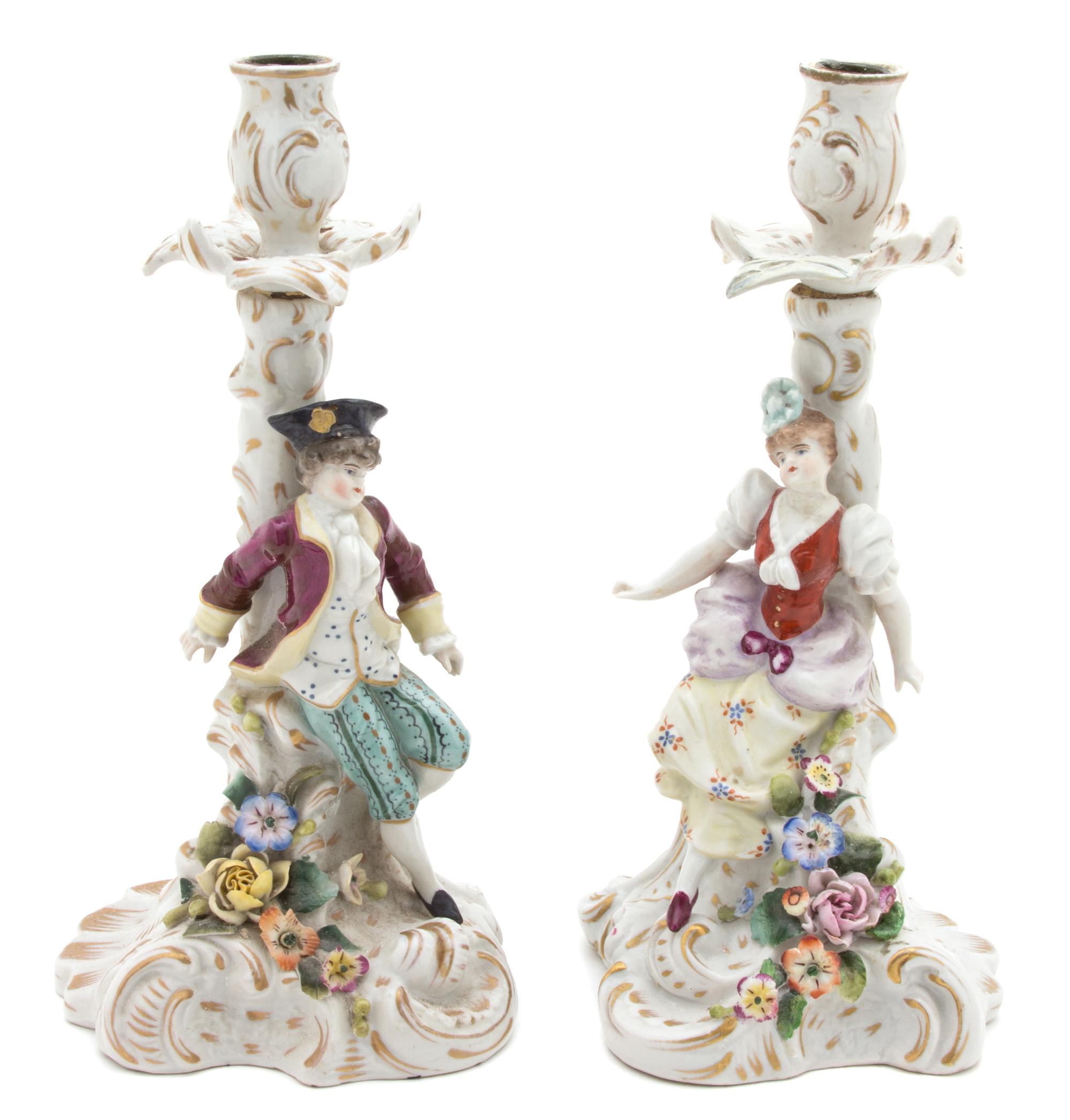A Pair of Continental Porcelain Candlesticks Height 9 1/2 inches. — 19TH CENTURY