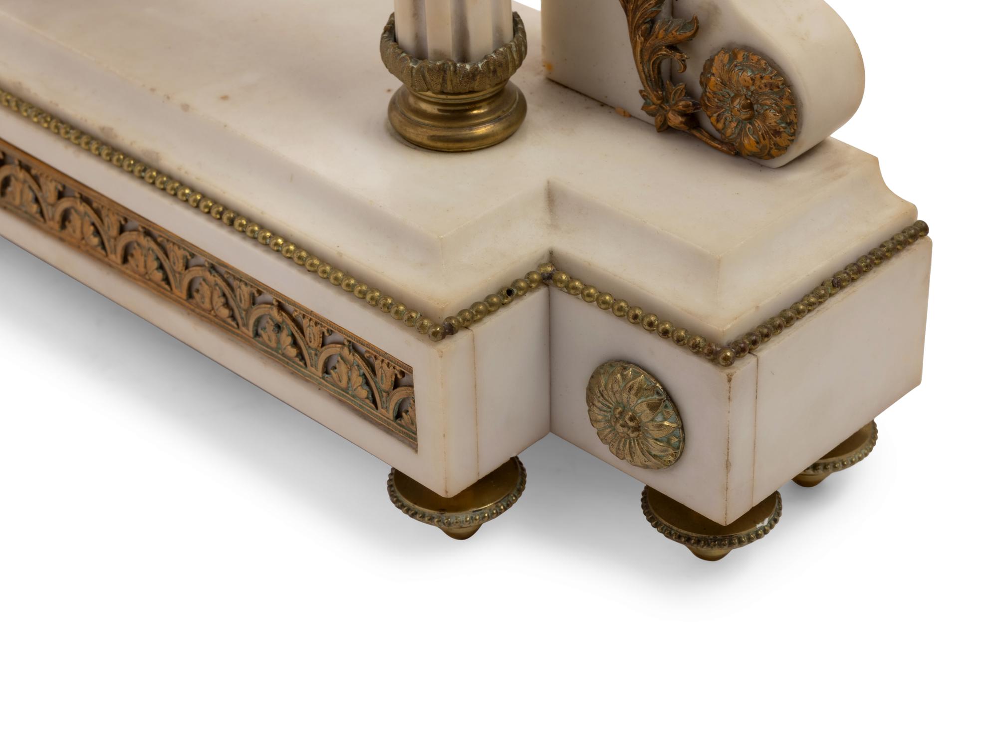 A French Gilt Metal Mounted Marble Three-Piece Clock Garniture