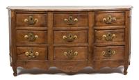 A Louis XV Provincial Style Carved Walnut Nine Drawer Serpentine Commode — 19TH/20TH CENTURY