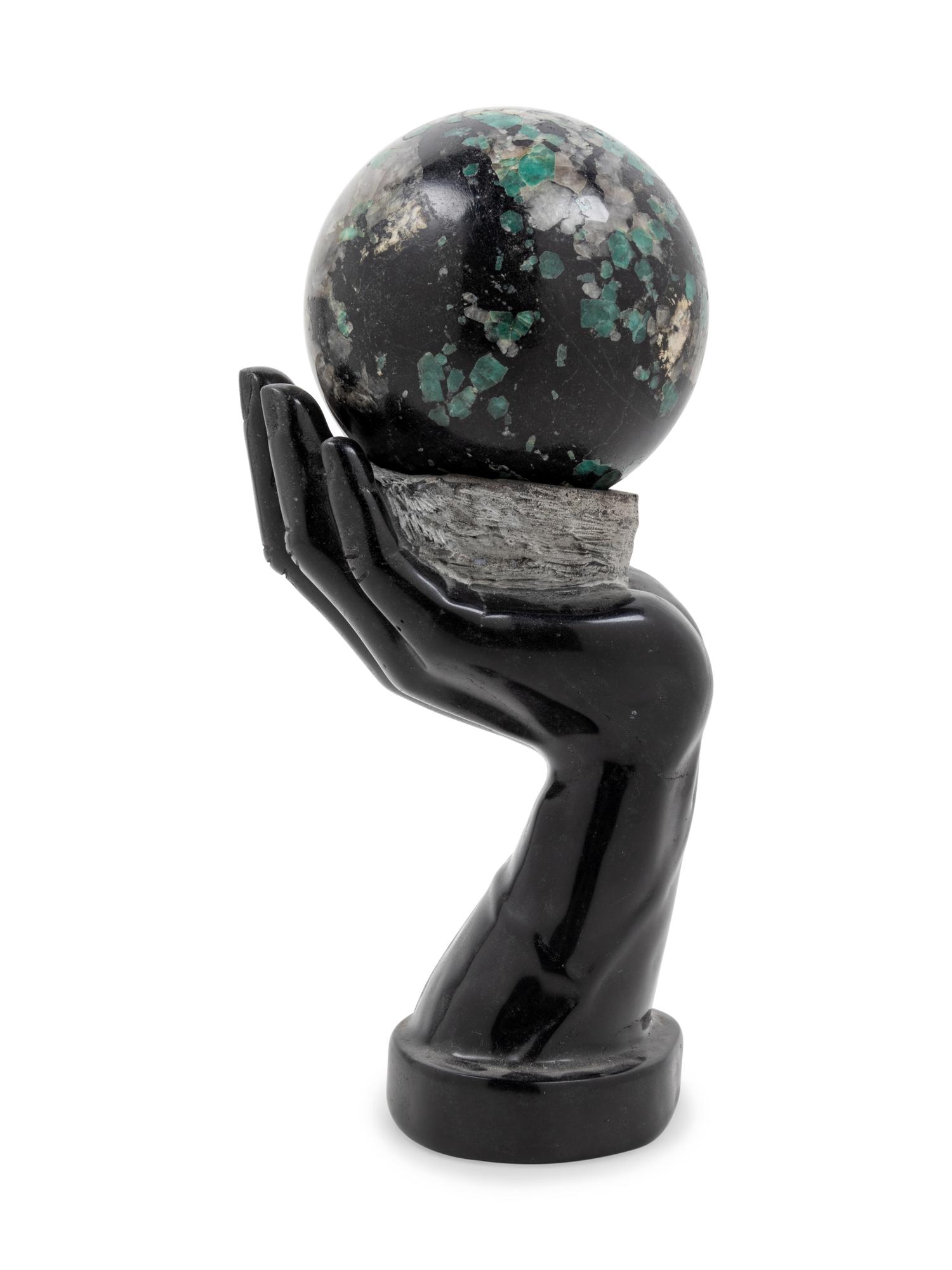 A Carved Hardstone Ornament Depicting a Globe in the Palm of a Hand