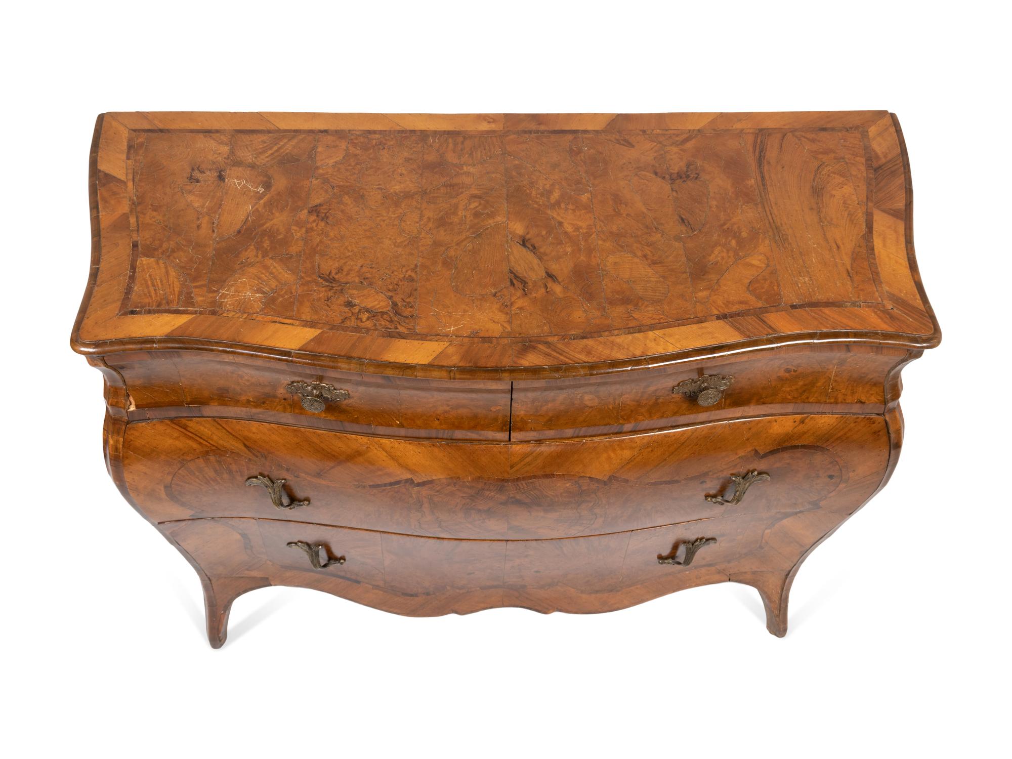 An Italian Rococo Style Walnut or Olivewood Bombe Chest of Drawers
