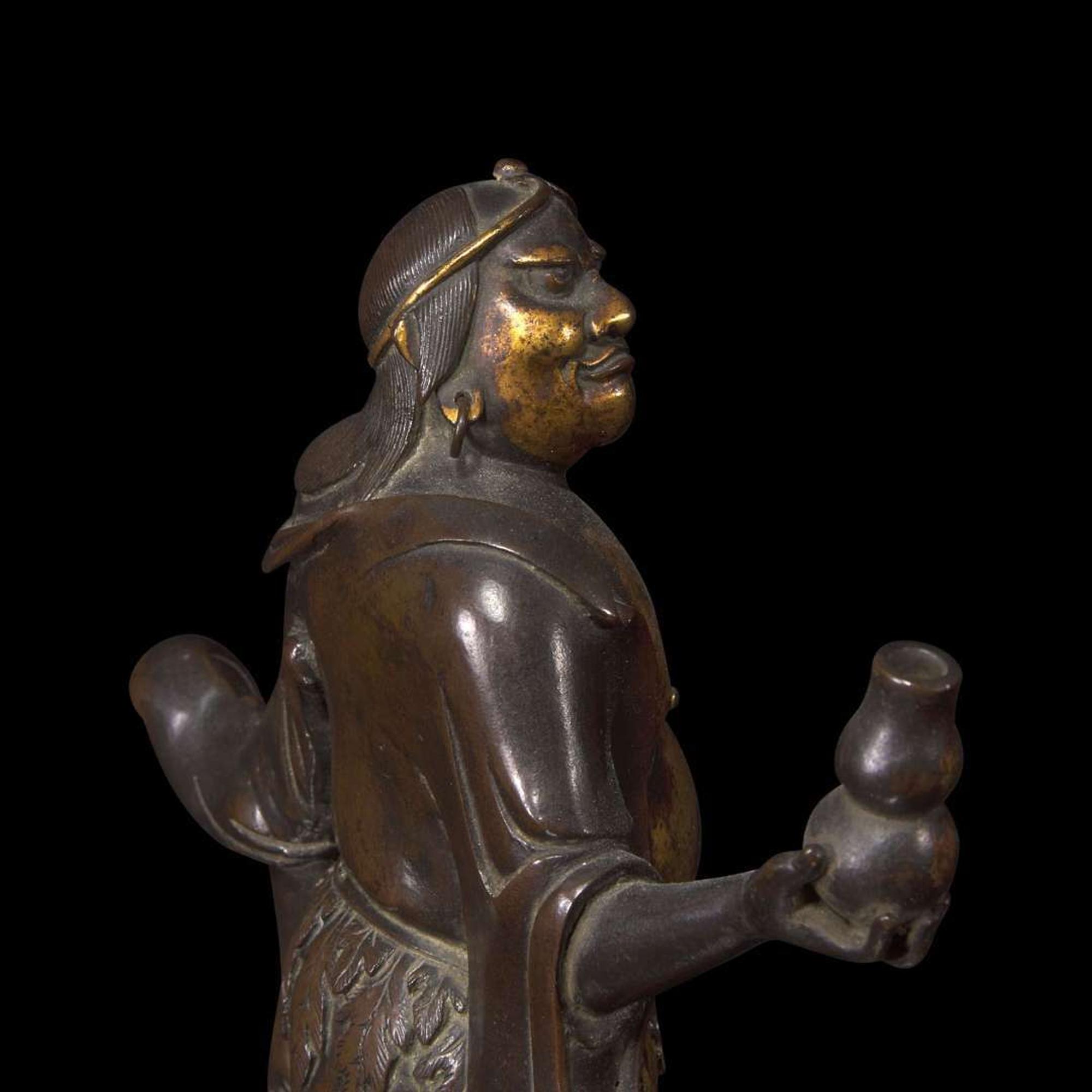 A finely modeled Chinese parcel-gilt and patinated bronze figure of Li Tieguai 部分漆金加画铁拐李铜造像 Late Ming/Early Qing dynasty ?????