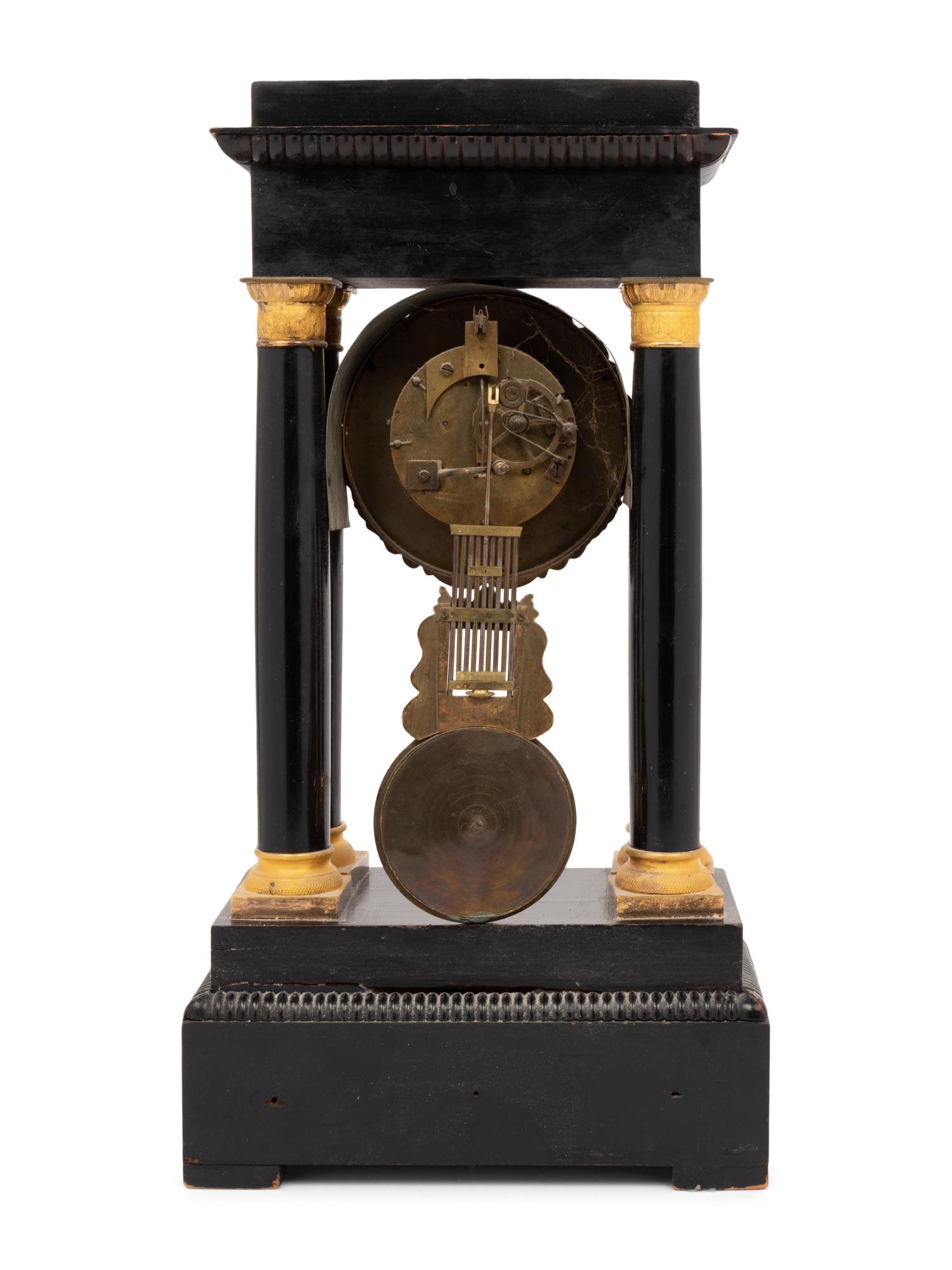 An Empire Style Gilt Bronze Mounted Ebonized Portico Clock