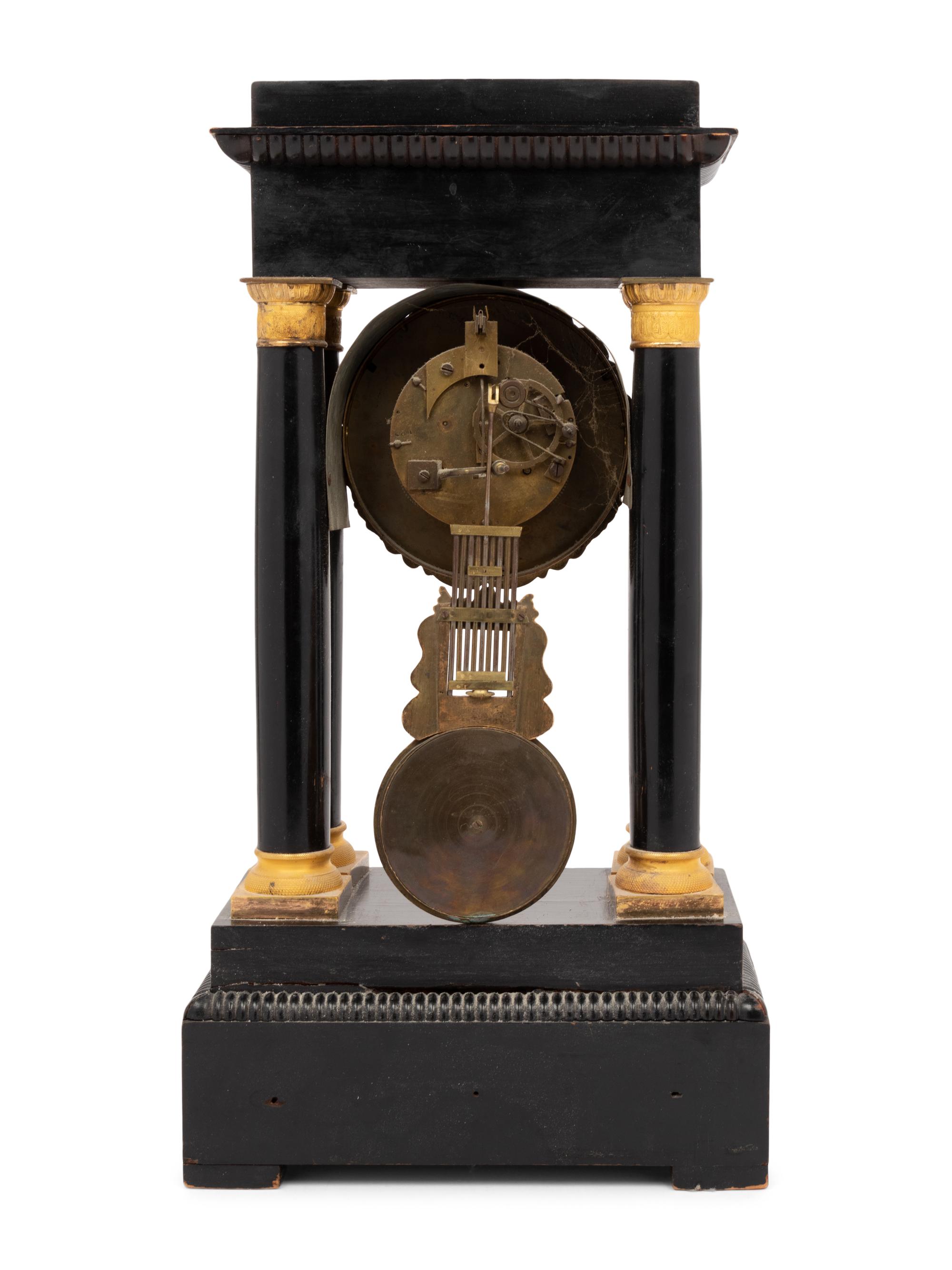 An Empire Style Gilt Bronze Mounted Ebonized Portico Clock