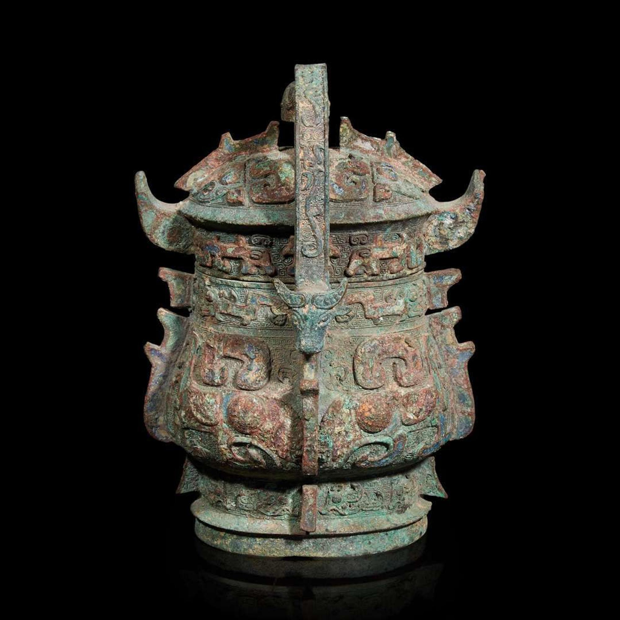 A Chinese archaistic bronze covered ritual wine vessel, You 青銅提梁卣