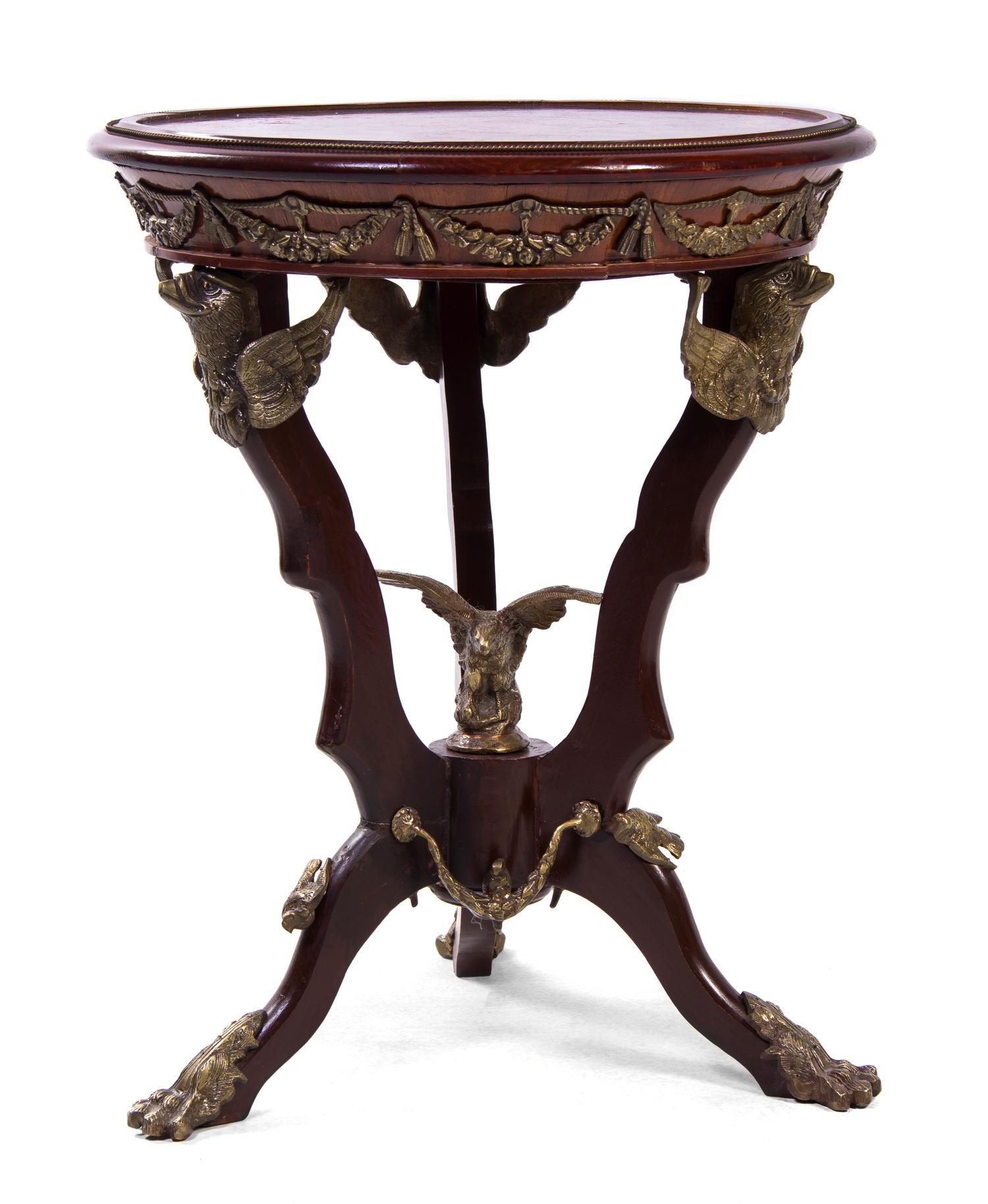 An Empire Style Gilt Metal Mounted Marquetry Decorated Mahogany Gueridon, Height 29 x diameter 23 1/2 inches.