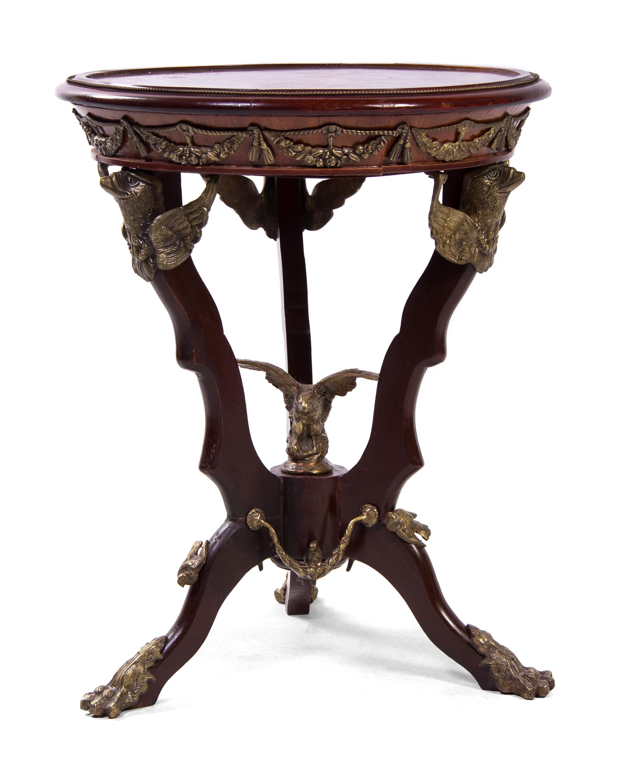 An Empire Style Gilt Metal Mounted Marquetry Decorated Mahogany Gueridon, Height 29 x diameter 23 1/2 inches.