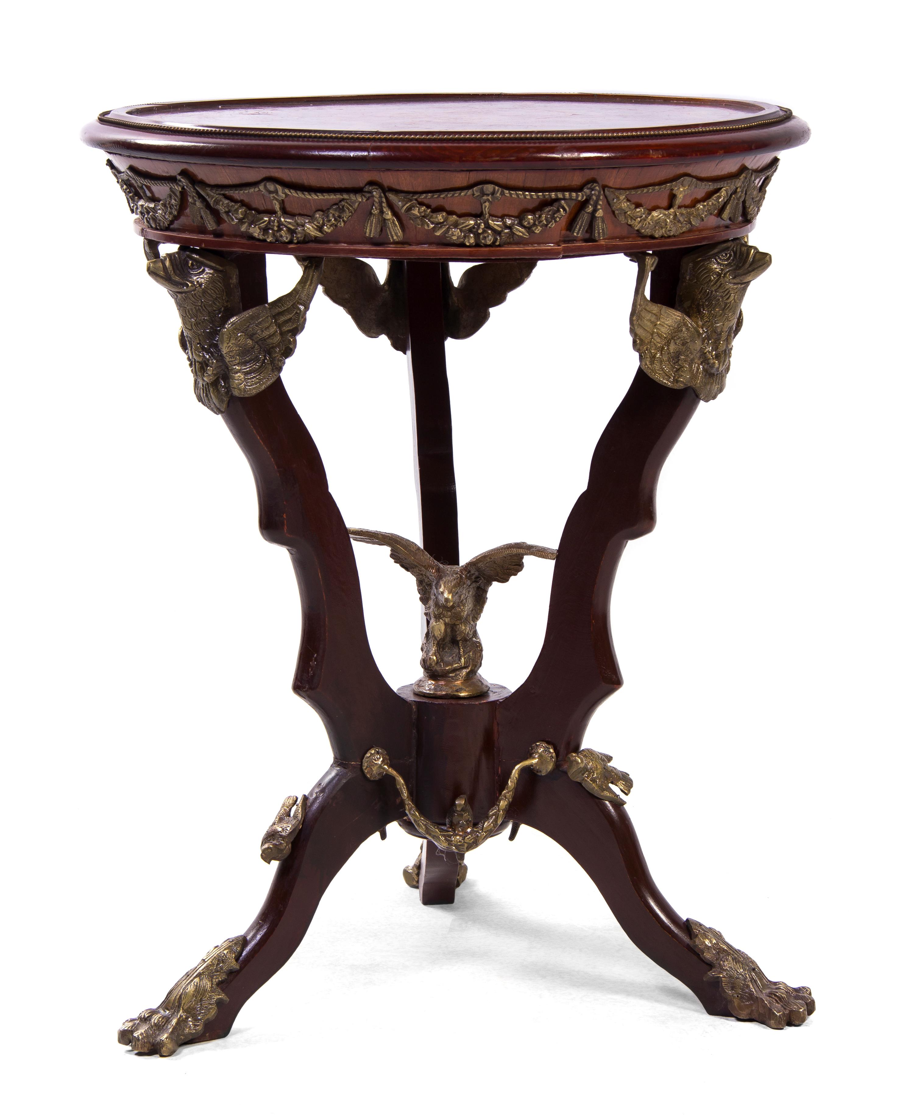 An Empire Style Gilt Metal Mounted Marquetry Decorated Mahogany Gueridon, Height 29 x diameter 23 1/2 inches.