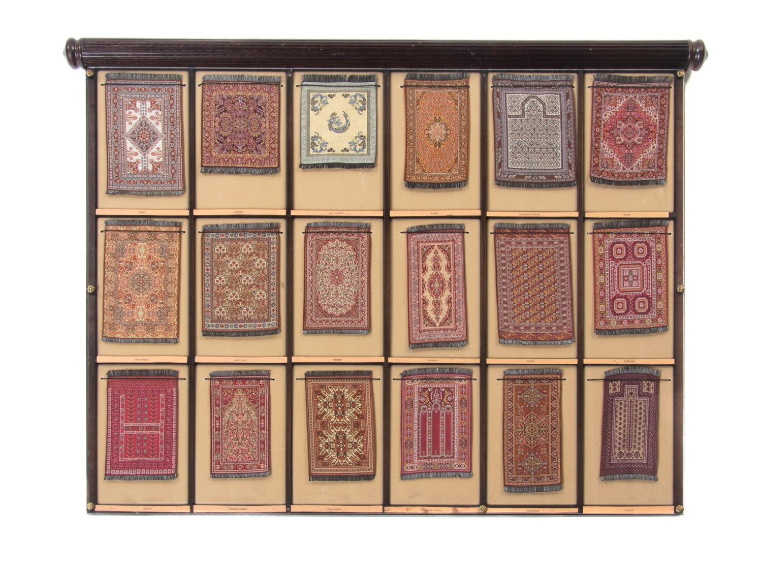 A Cased Set of Miniature Persian Rugs, Width overall 33 inches.