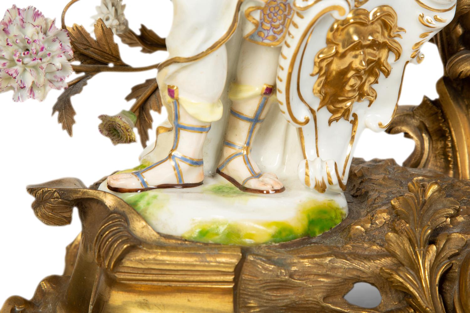 A Continental Gilt Bronze and Porcelain Figural Mantel Clock
