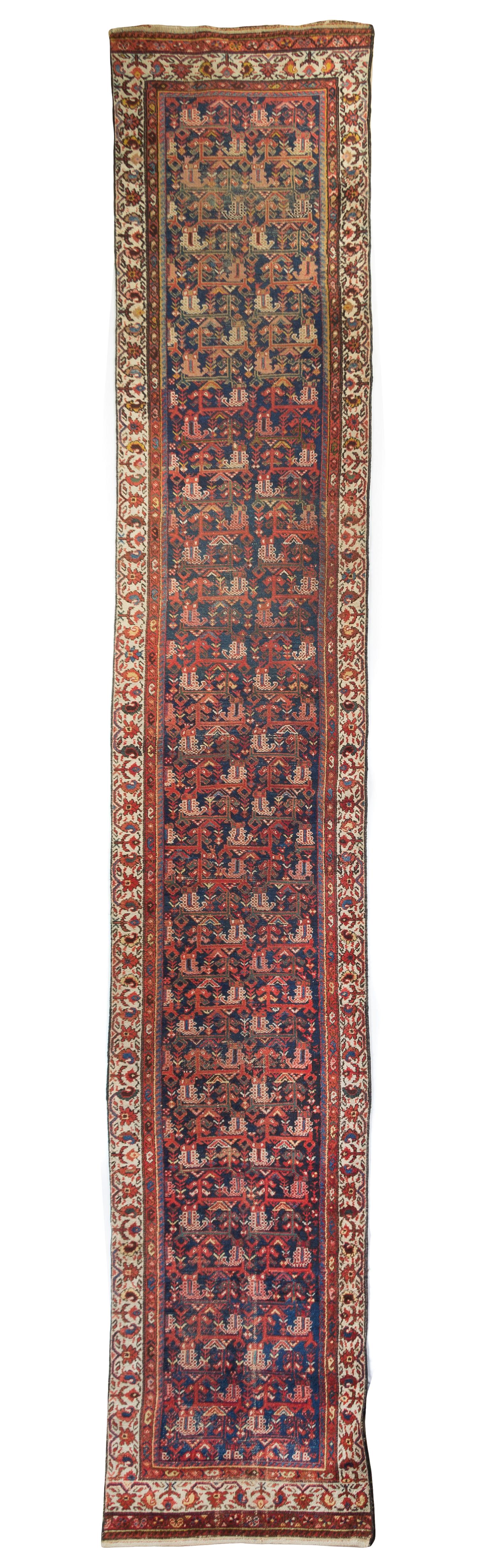 A Persian Wool Runner 16 feet x 2 feet 9 3/4 inches.
