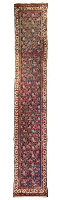 A Persian Wool Runner 16 feet x 2 feet 9 3/4 inches.