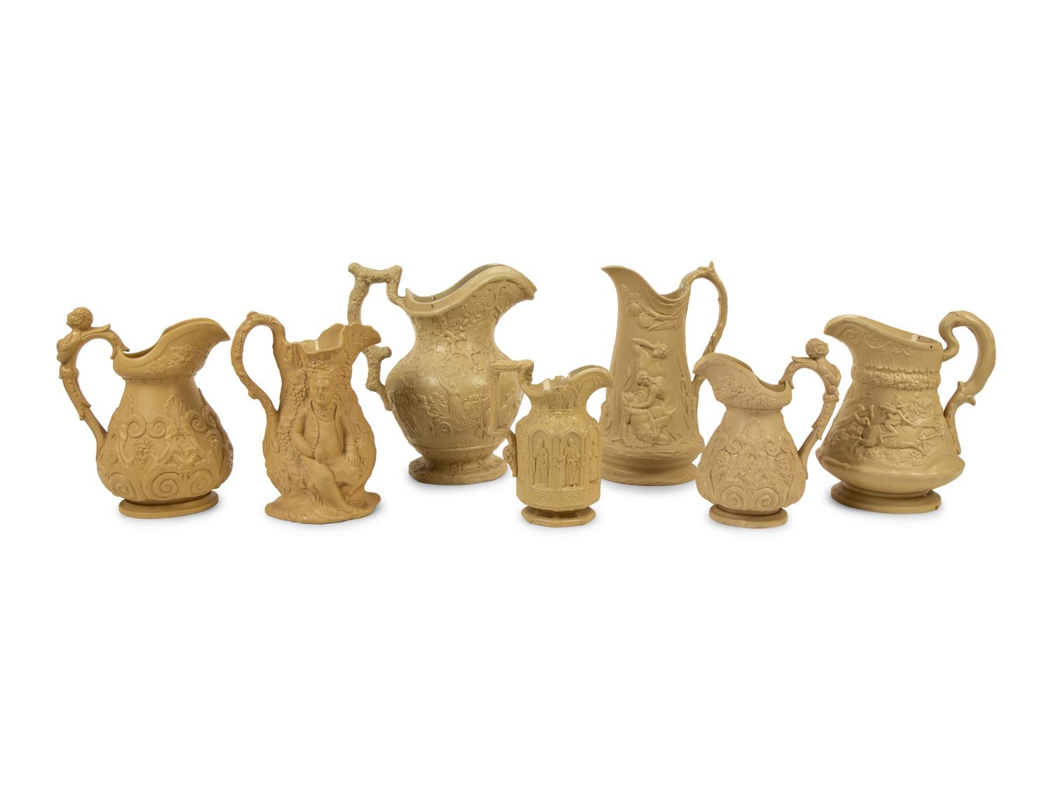 A Collection of Seven English Salt Glazed Relief Form Pitchers — 19TH/20TH CENTURY