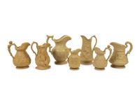 A Collection of Seven English Salt Glazed Relief Form Pitchers — 19TH/20TH CENTURY
