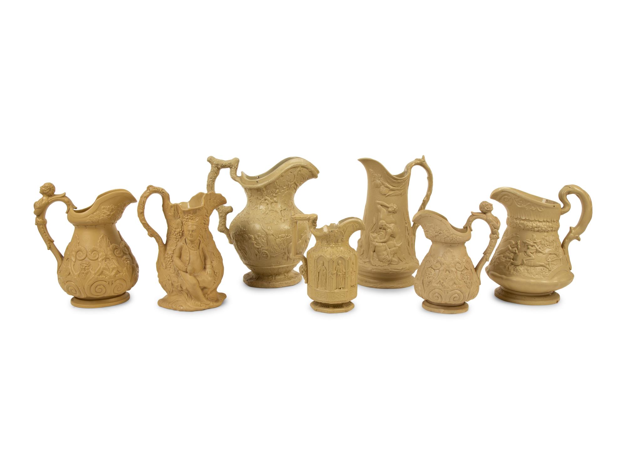 A Collection of Seven English Salt Glazed Relief Form Pitchers — 19TH/20TH CENTURY