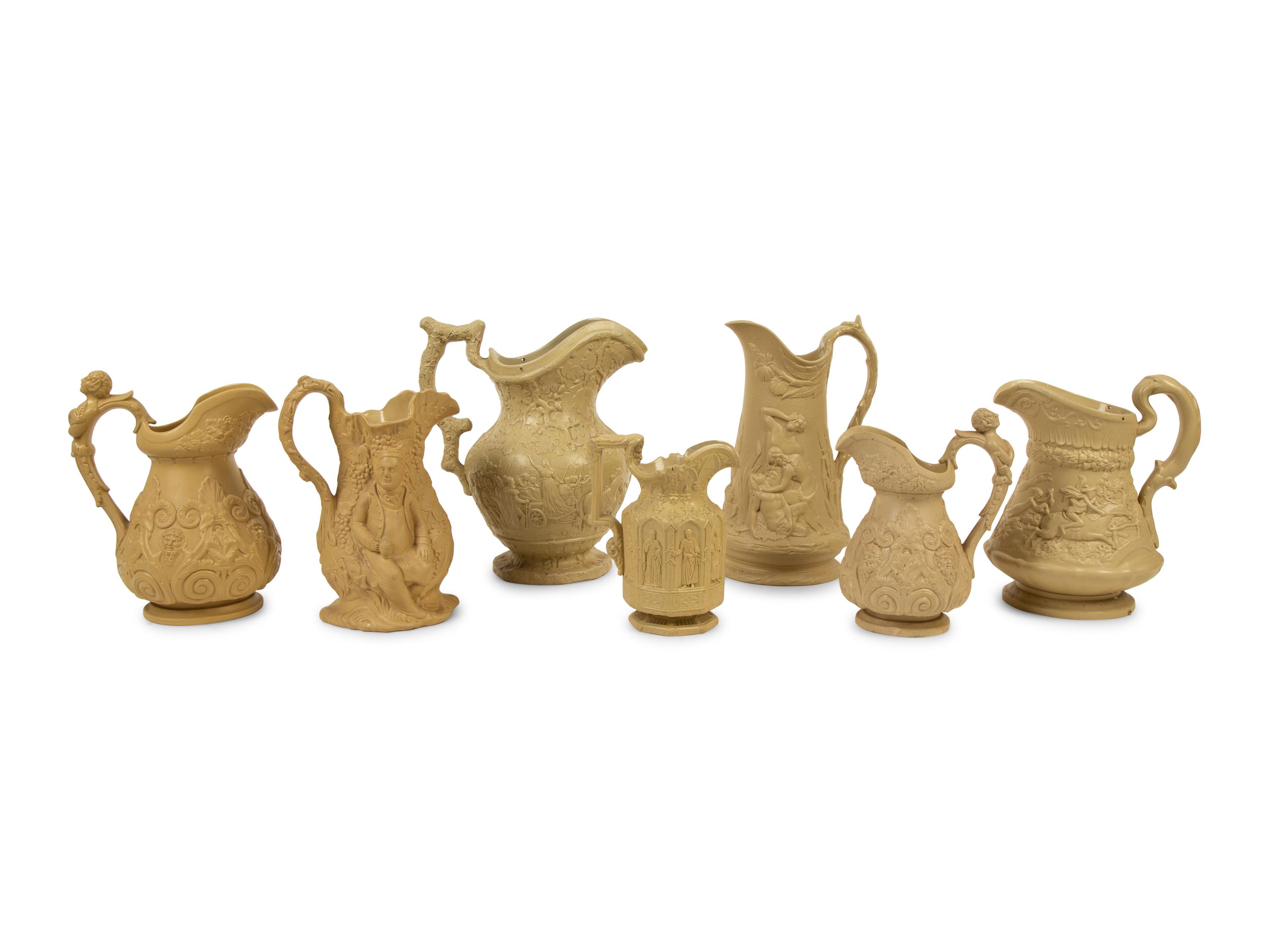 A Collection of Seven English Salt Glazed Relief Form Pitchers — 19TH/20TH CENTURY