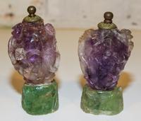 A Pair of Carved Amethyst Snuff Bottles Height of each 5 inches.