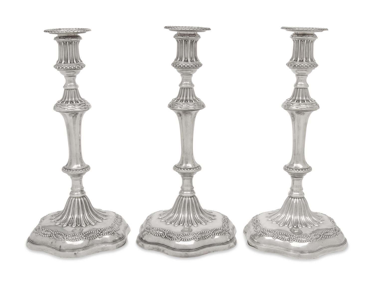 A Set of Three George III Silver Candlesticks
