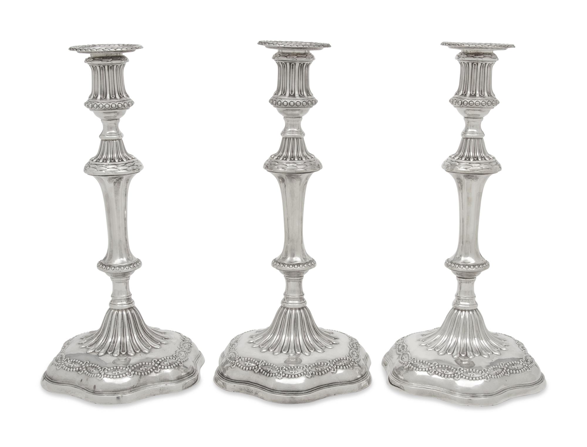 A Set of Three George III Silver Candlesticks