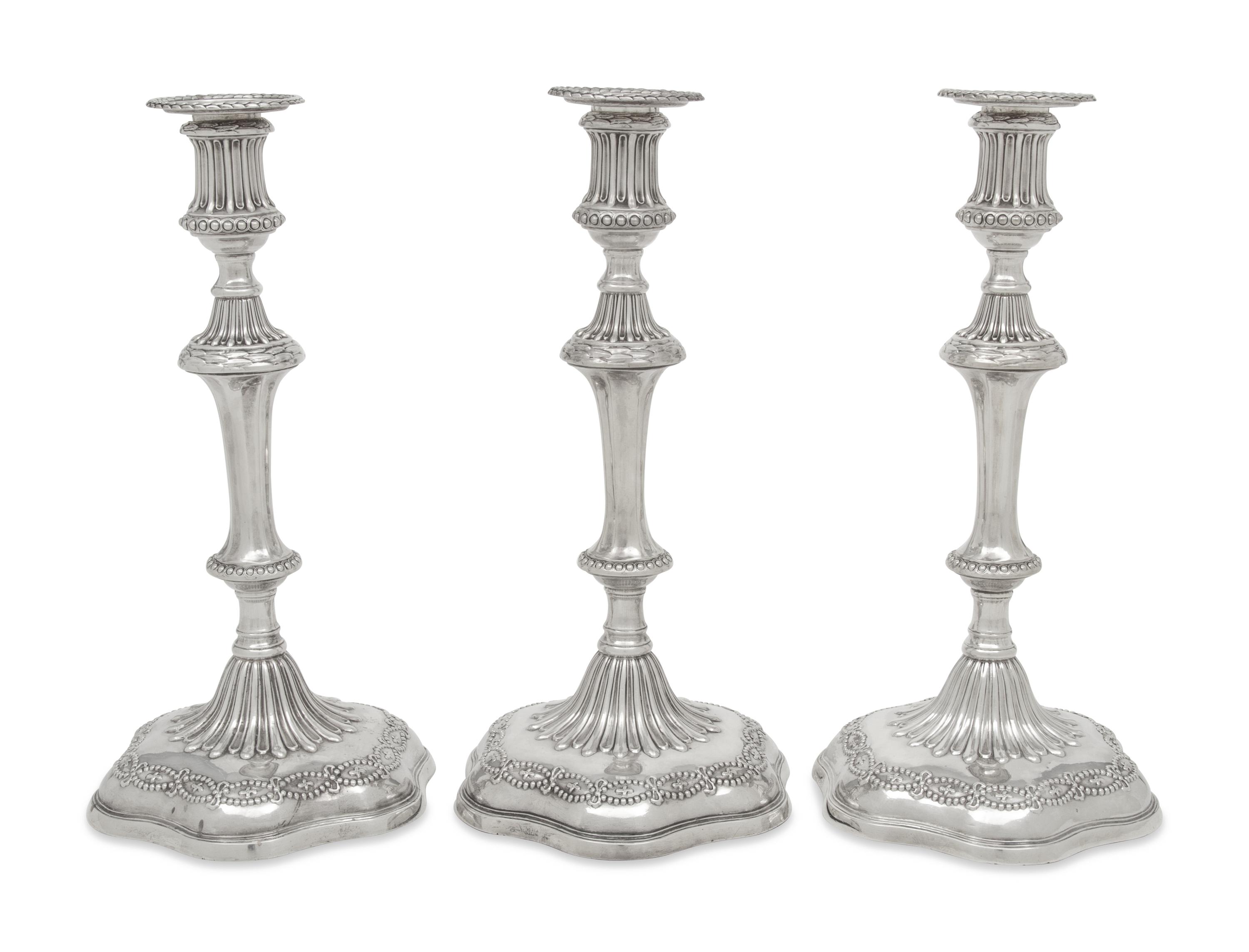 A Set of Three George III Silver Candlesticks
