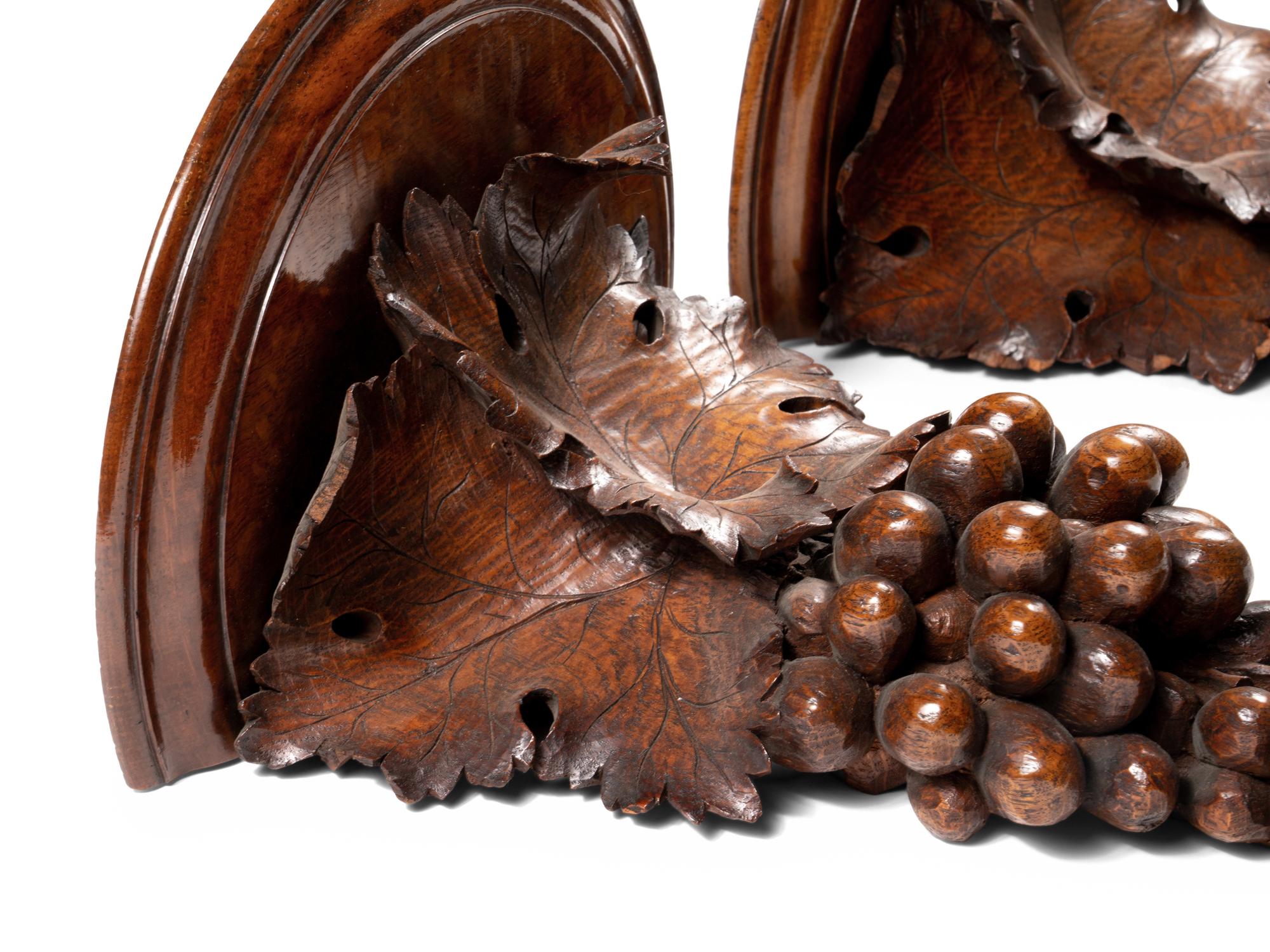 A Pair of Continental Carved Walnut Wall Brackets