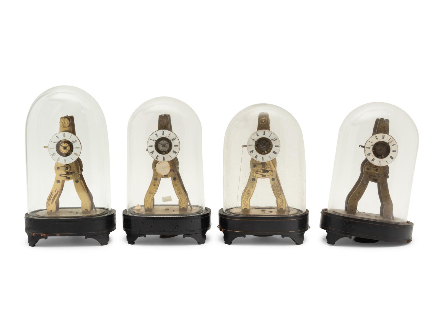 A Group of Four Brass Skeleton Clocks