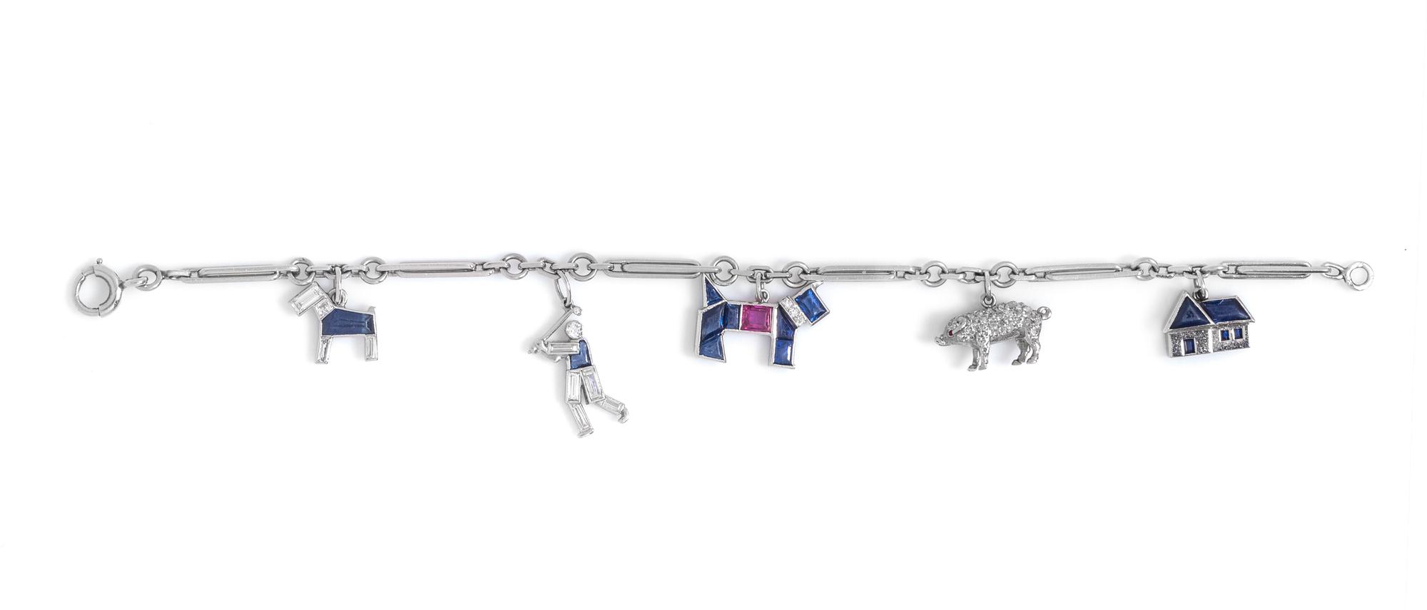 An Art Deco Platinum, Diamond, Ruby and Sapphire Charm Bracelet, Cartier,