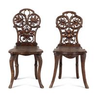 A Pair of Black Forest Oak Leaf Carved Side Chairs